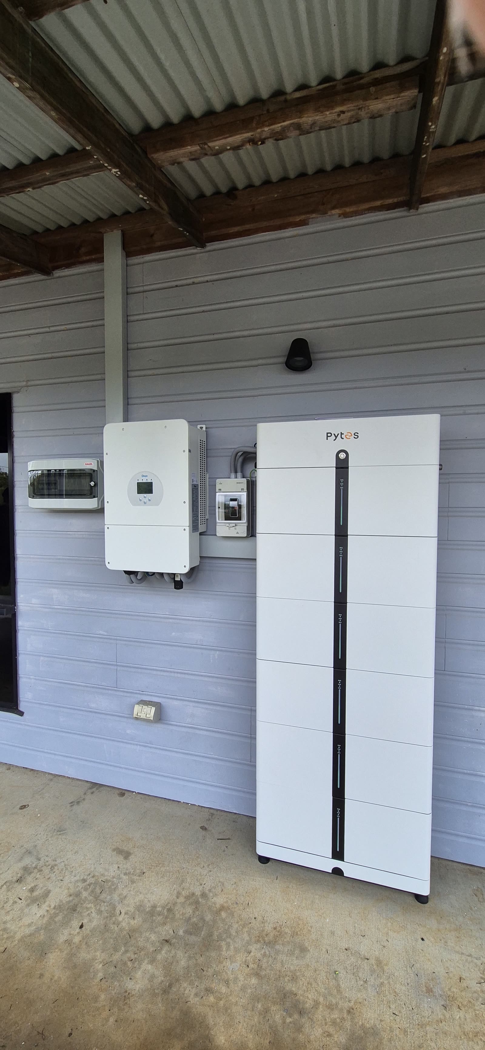 Pytes Pi LV1 stack mounted beside a Deye hybrid inverter in a carport